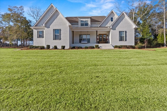 view of front of house with a porch and a front yard