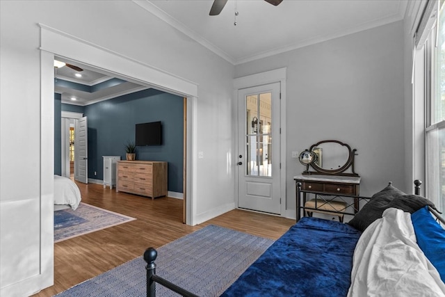 bedroom with ceiling fan, hardwood / wood-style floors, and crown molding