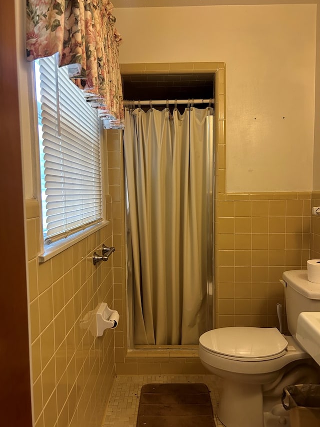 bathroom with a shower with curtain, plenty of natural light, and tile walls