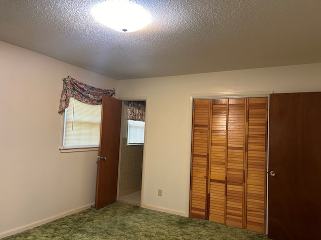 unfurnished bedroom featuring carpet floors, a textured ceiling, and a closet