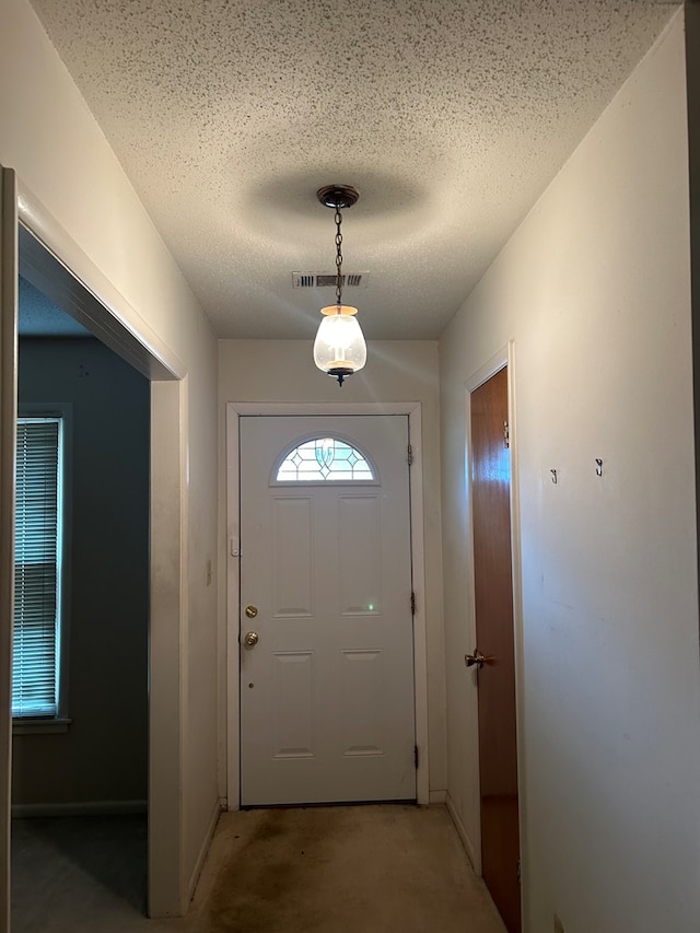 doorway with a textured ceiling