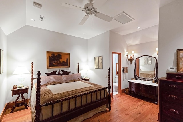 bedroom with ceiling fan, ensuite bathroom, light hardwood / wood-style floors, and vaulted ceiling