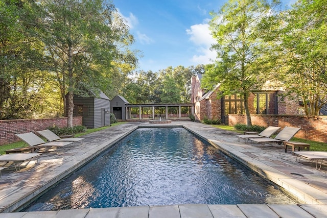 view of pool with an outbuilding and a patio area