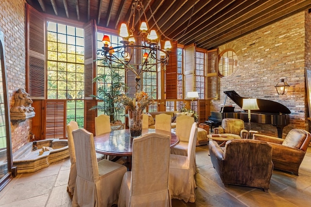 dining space with wood ceiling, beamed ceiling, a chandelier, and a high ceiling