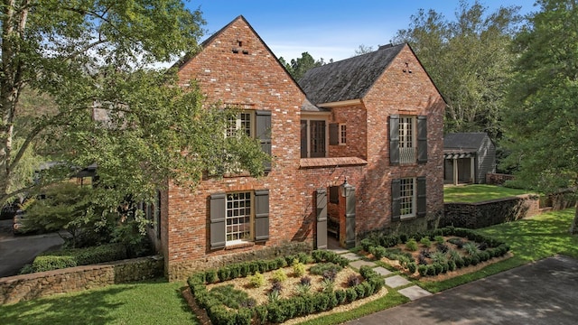 tudor-style house with a front lawn