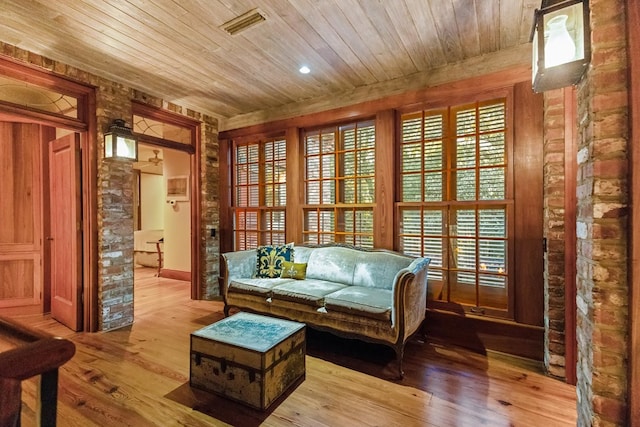 sitting room featuring light hardwood / wood-style floors and wood ceiling