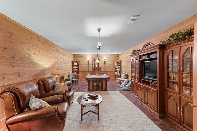 living room with wooden walls and pool table