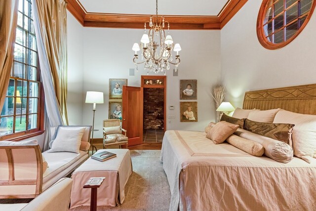 bedroom featuring hardwood / wood-style flooring, crown molding, and a chandelier