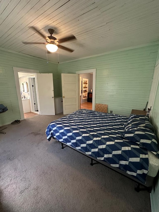 unfurnished bedroom with carpet floors, ensuite bathroom, ceiling fan, and wood ceiling