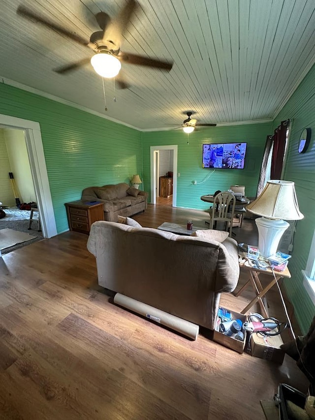 living room featuring wood-type flooring, crown molding, and wooden ceiling