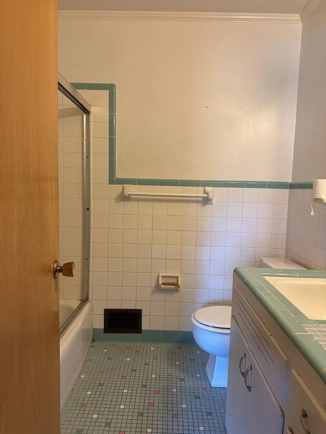 full bathroom featuring tile patterned flooring, vanity, toilet, and tile walls