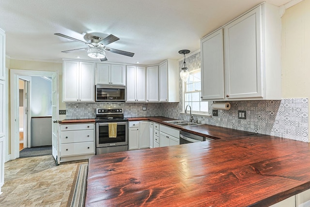 1810 Northside Dr, Dothan, AL 36303 - kitchen featuring wooden counters, stainless steel appliances, a sink, a ceiling fan, and decorative backsplash