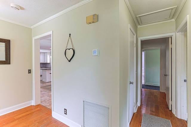 1810 Northside Dr, Dothan, AL 36303 - hallway featuring light wood-type flooring, attic access, crown molding, and baseboards