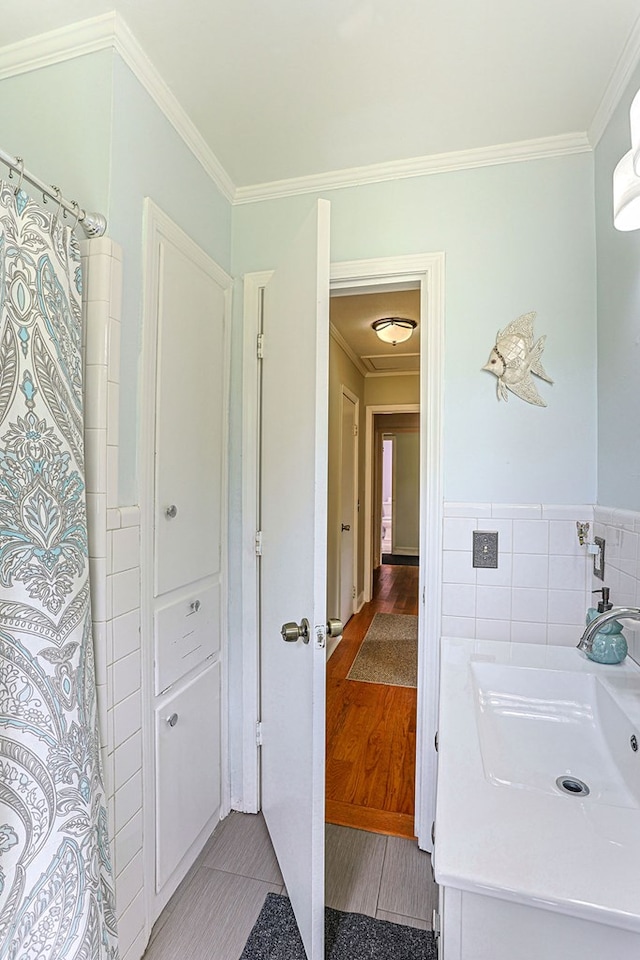1810 Northside Dr, Dothan, AL 36303 - bathroom featuring ornamental molding, vanity, tile walls, a wainscoted wall, and a shower with shower curtain