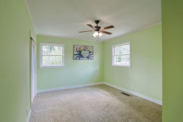 1810 Northside Dr, Dothan, AL 36303 - carpeted empty room with crown molding, plenty of natural light, ceiling fan, and baseboards