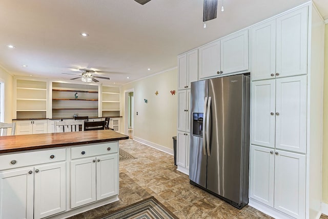 1810 Northside Dr, Dothan, AL 36303 - kitchen with stainless steel refrigerator with ice dispenser, butcher block countertops, a ceiling fan, white cabinets, and baseboards