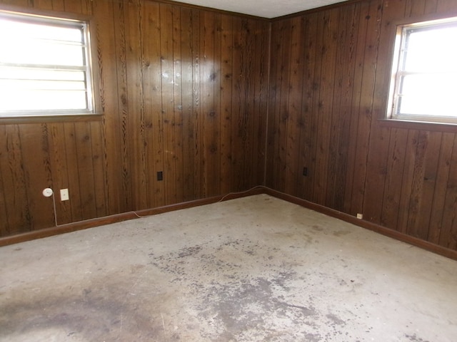 unfurnished room featuring wood walls