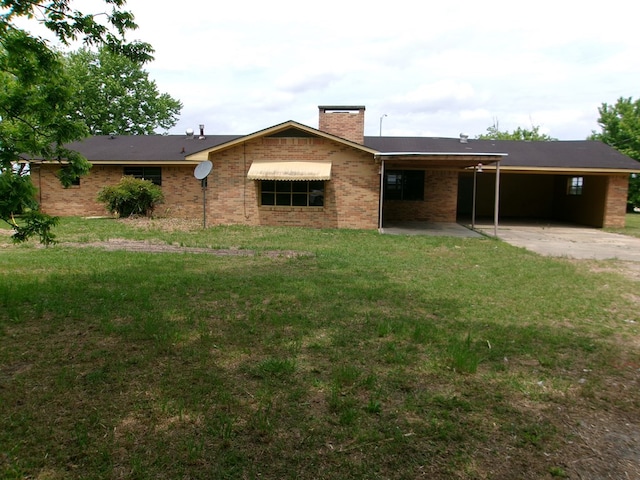 single story home featuring a chimney, a front lawn, and a carport
