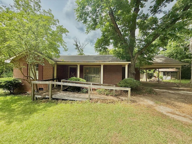 152 W Cox St, Slocomb, AL 36375 - rear view of house featuring a yard, brick siding, a carport, and driveway