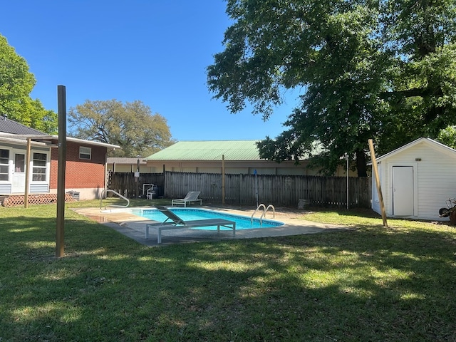 view of swimming pool with a storage shed, a yard, fence, and an outdoor structure