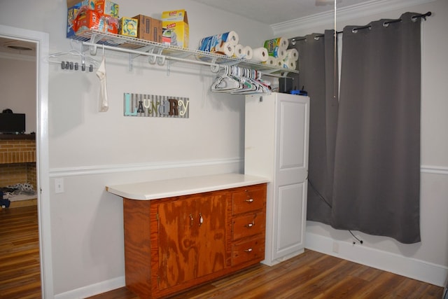 walk in closet with dark wood-style flooring