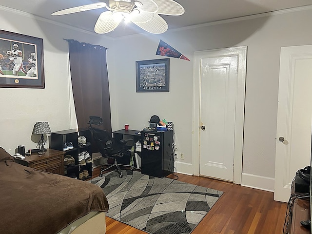bedroom with ornamental molding, ceiling fan, wood finished floors, and baseboards