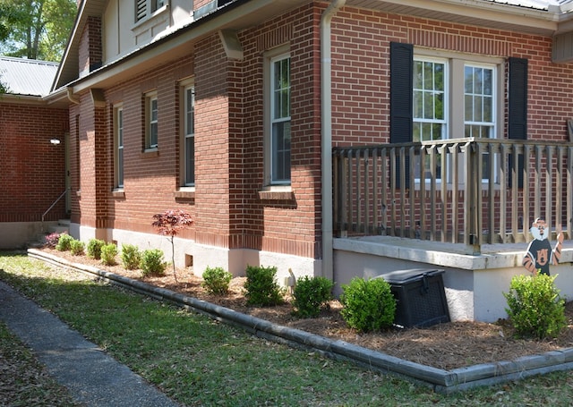 view of home's exterior featuring brick siding and metal roof