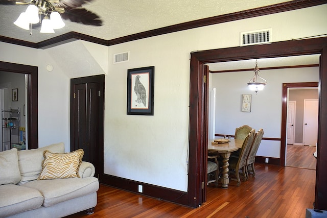 living room with ornamental molding, ceiling fan, dark wood-style floors, and visible vents