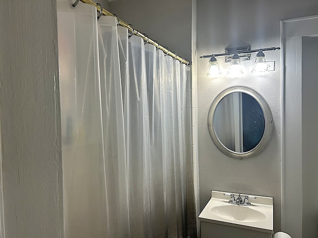 full bath with vanity and a shower with curtain