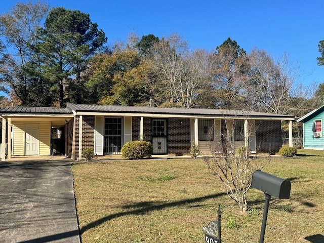 ranch-style home featuring a front yard, a porch, and a carport