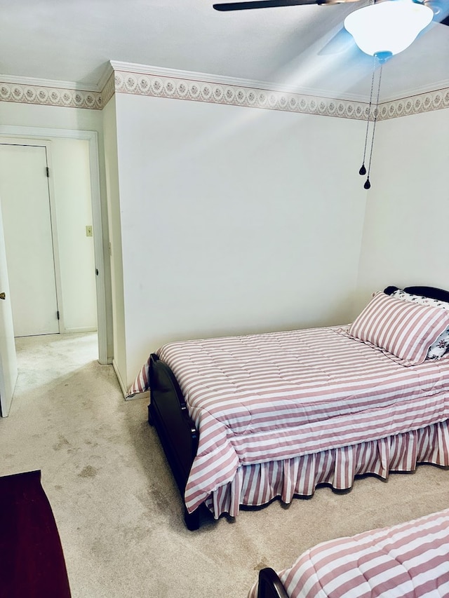bedroom featuring crown molding, ceiling fan, and light carpet