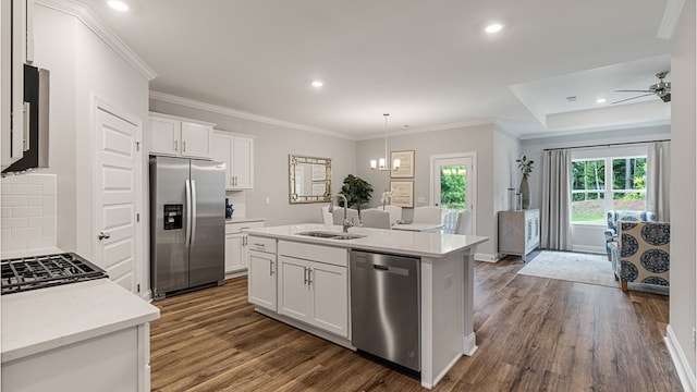 kitchen featuring stainless steel appliances, dark wood-style flooring, a sink, and white cabinets