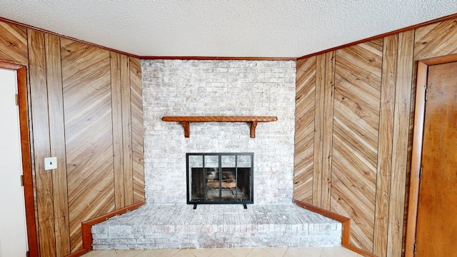 interior details with wood walls, ornamental molding, and a textured ceiling