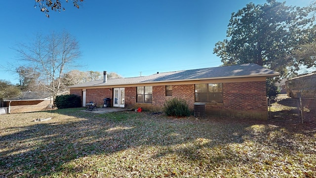 rear view of property with a yard