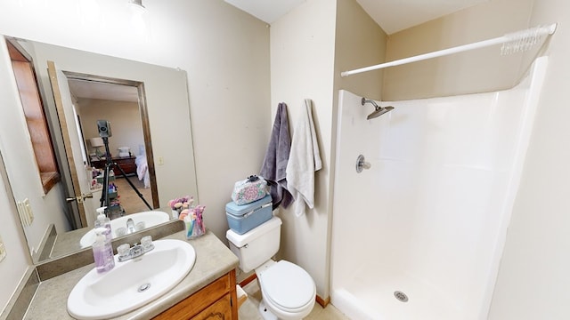 bathroom featuring vanity, toilet, and walk in shower