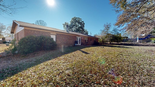 view of side of home with a lawn