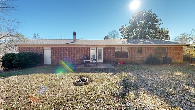 back of property featuring a yard, central AC, and a patio area