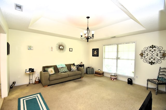 2023 Brackin Dr, Dothan, AL 36301 - living room featuring a tray ceiling, carpet flooring, a chandelier, and baseboards