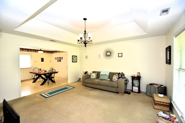 2023 Brackin Dr, Dothan, AL 36301 - living area featuring a raised ceiling, light colored carpet, and a chandelier