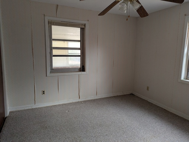 unfurnished room with ceiling fan and carpet floors