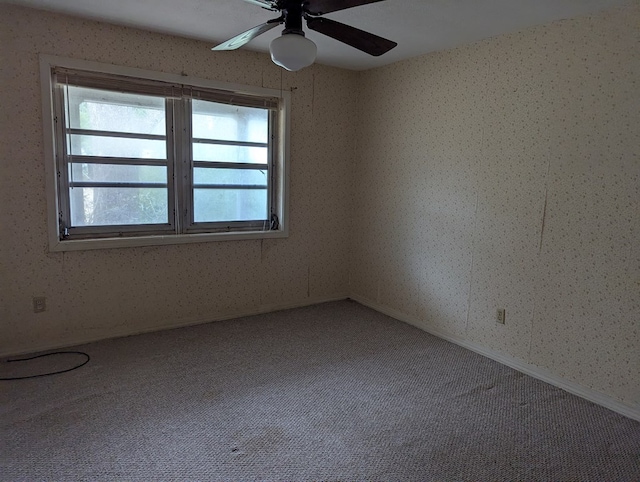 carpeted empty room featuring ceiling fan