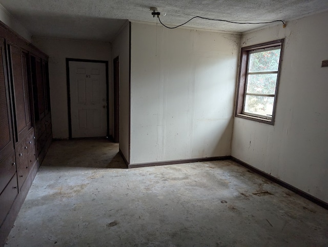 spare room with a textured ceiling