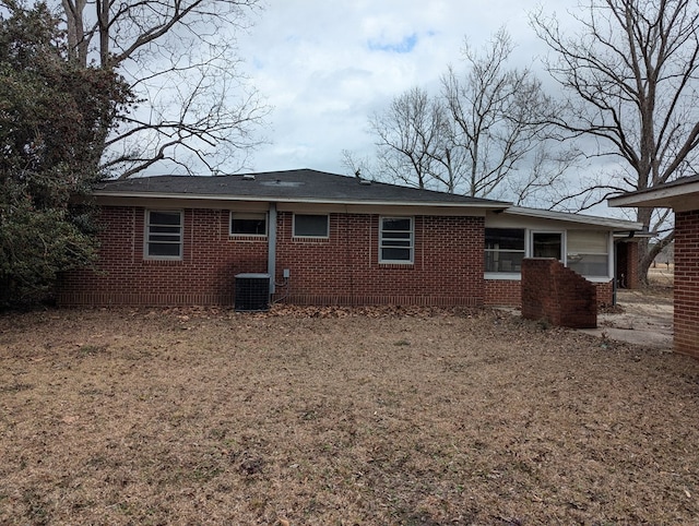 back of house featuring cooling unit and a lawn