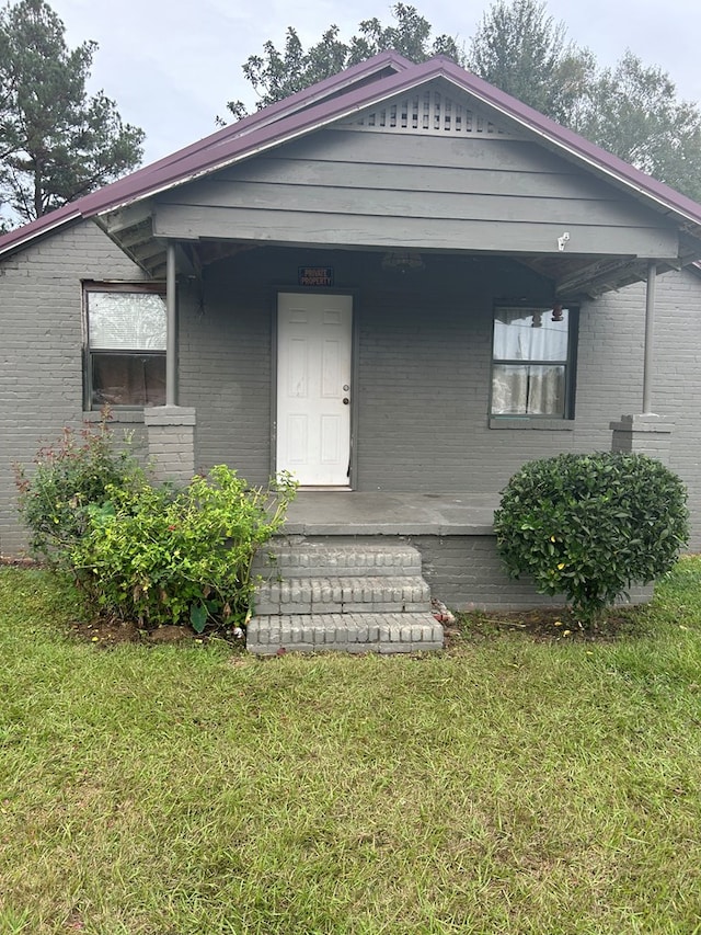 bungalow with a porch and a front yard