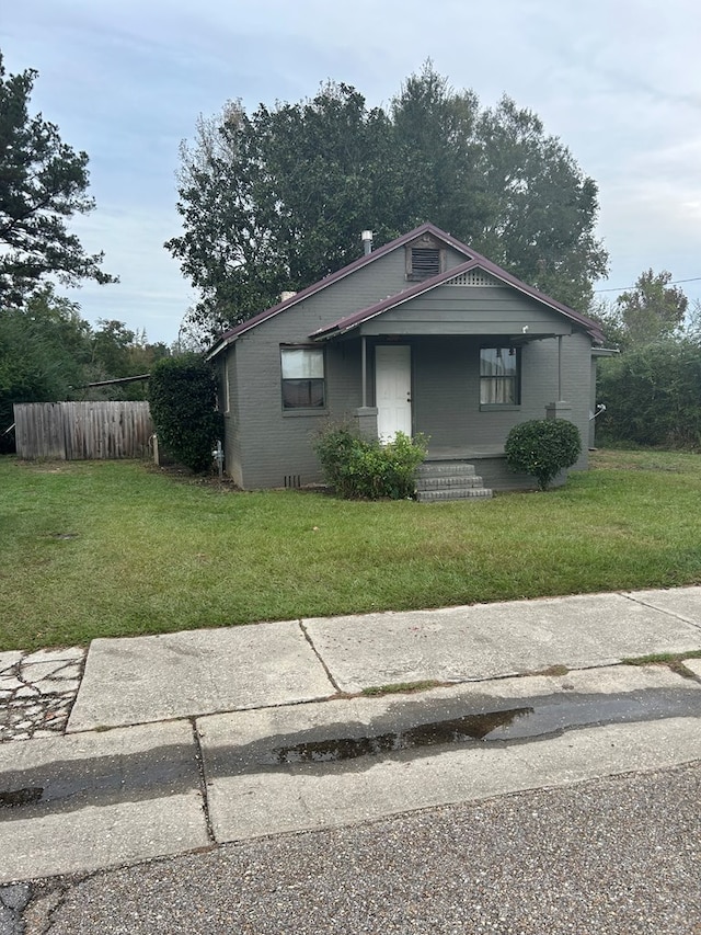 bungalow-style house featuring a front yard