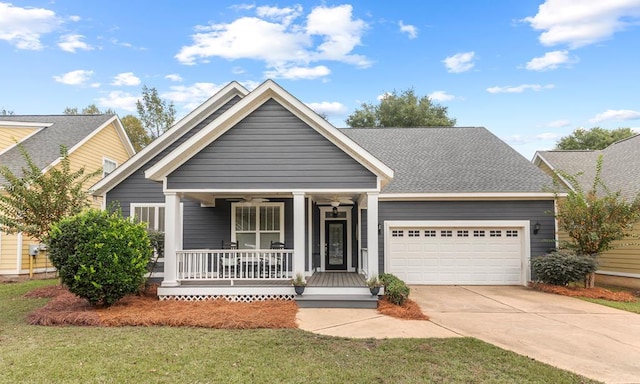 craftsman inspired home featuring a porch, a garage, and a front lawn