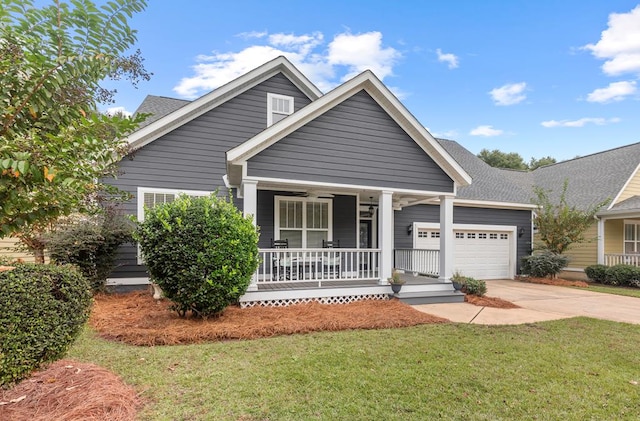 craftsman-style house with a front lawn, a porch, and a garage