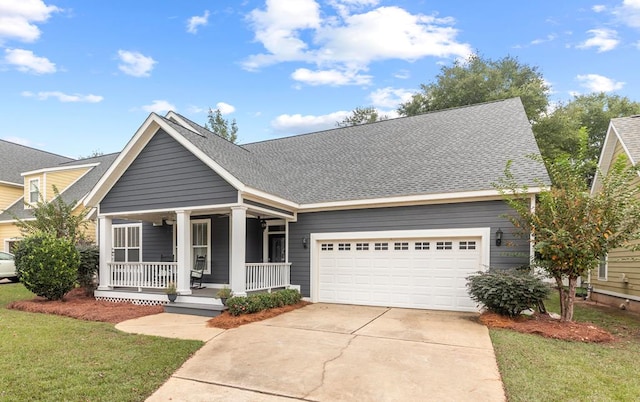 view of front of home with a porch, a garage, and a front lawn