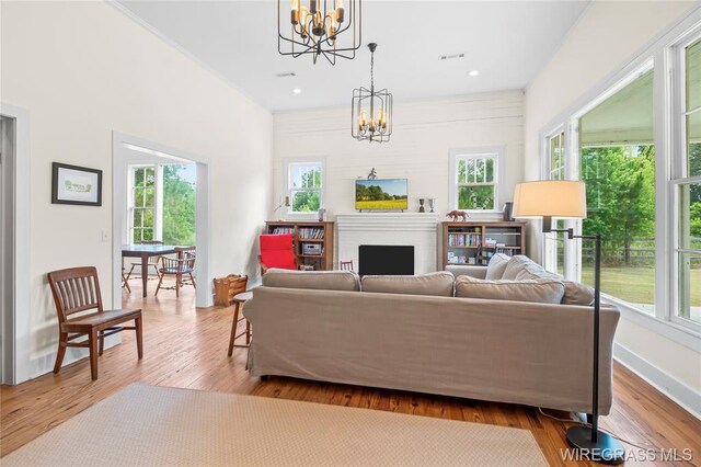 5606 Rocky Creek Rd, Ashford, AL 36312 - living room with a chandelier, wood finished floors, a fireplace, and recessed lighting