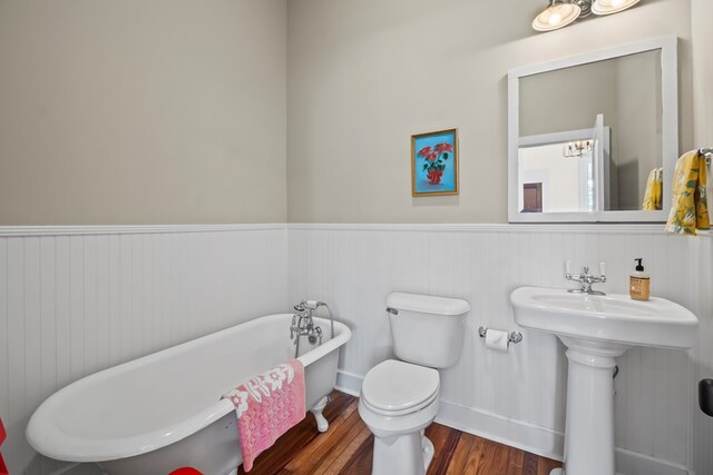 5606 Rocky Creek Rd, Ashford, AL 36312 - bathroom featuring a freestanding bath, wainscoting, and wood finished floors